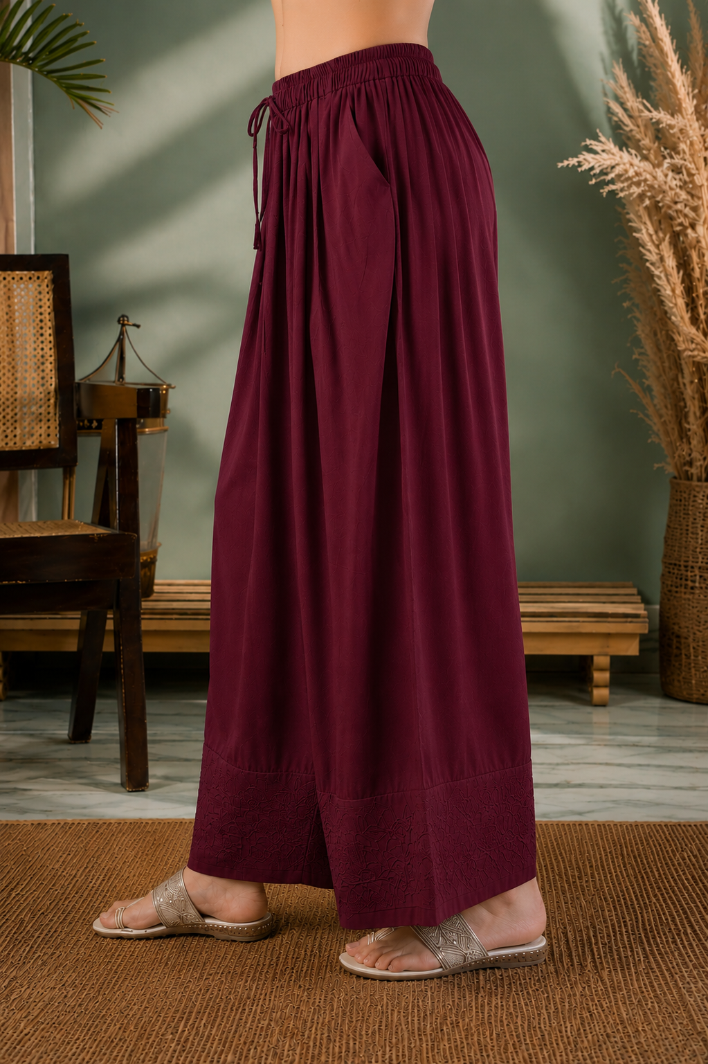 Maroon farshi salwar in motion showing embroidered hem