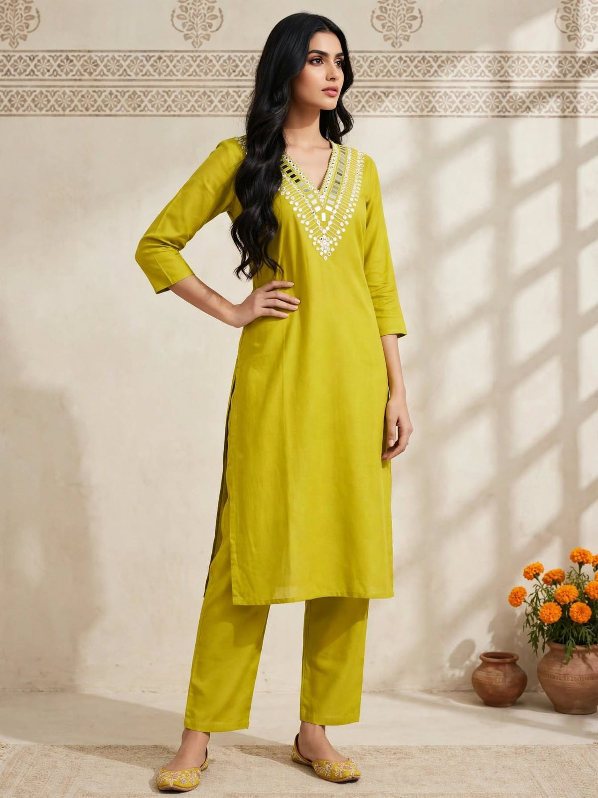 Woman wearing a lime green V-neck embellished kurta with trousers