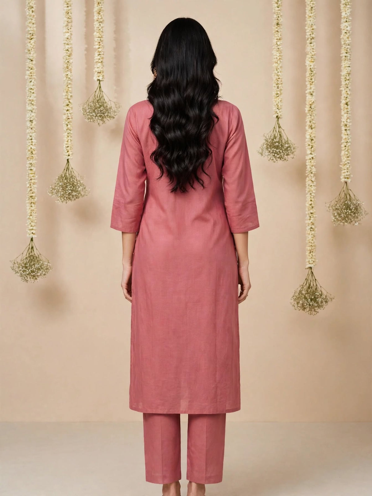 Close-up of delicate embroidery on dusty rose kurta neckline